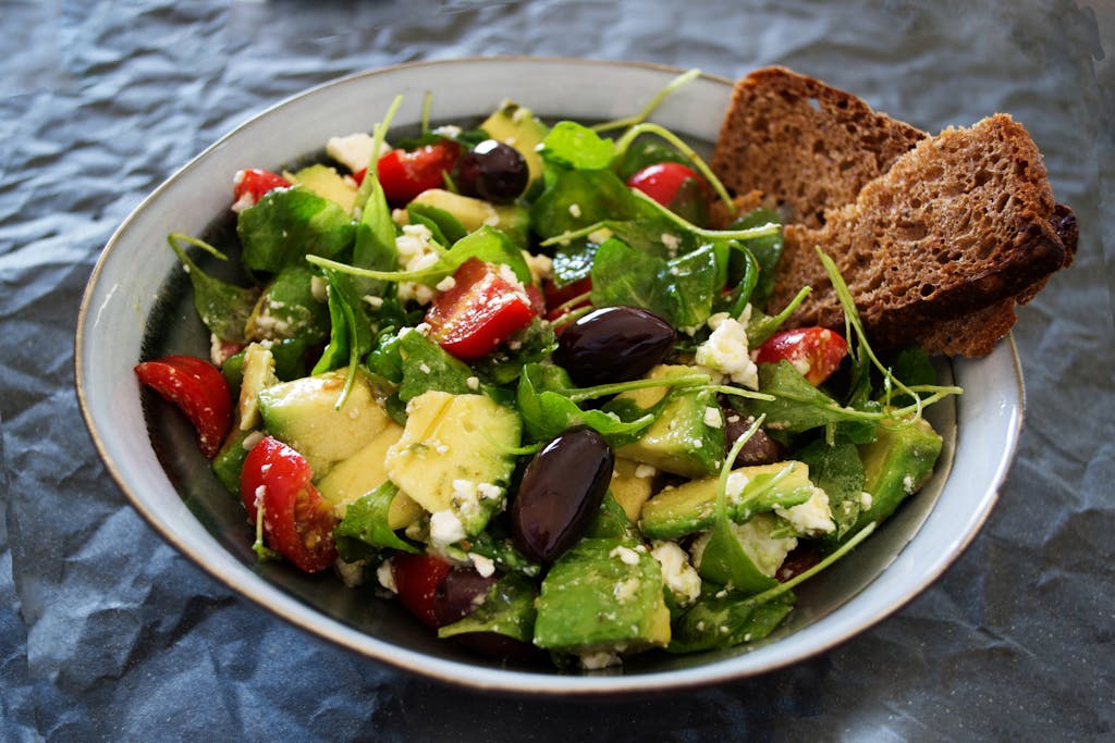 Delicious Greek salad featuring avocado, feta, and olives, ideal for a healthy meal.